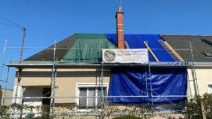 finition soignée d'arêtier en ardoises naturelles sur toiture